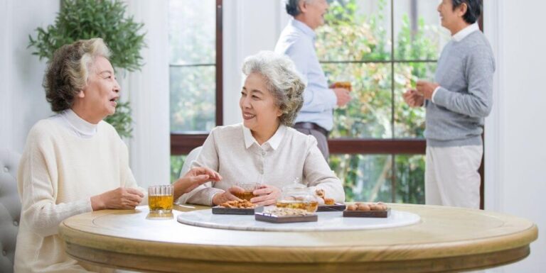 Two Happy Seniors Eating at Memory Care Facility