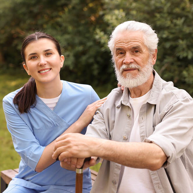 Caregiver Comforting Resident at Memory Care Facility
